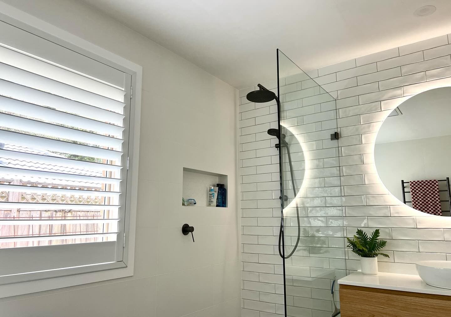 Bathroom — frameless shower with plantation shutters