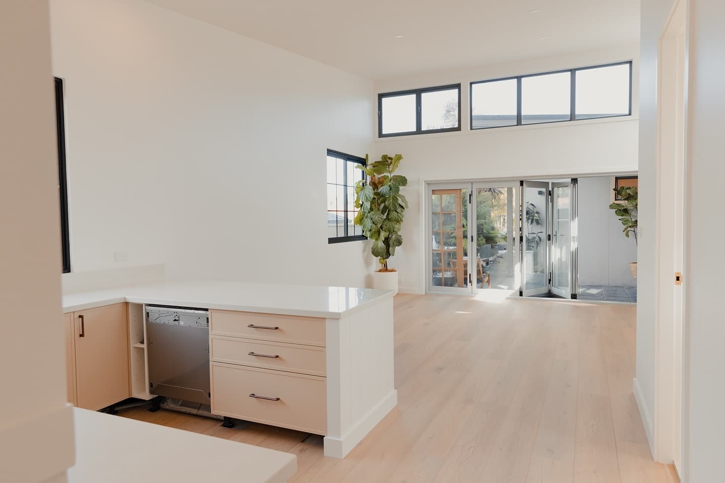 Open plan kitchen and living with bi-fold doors and double-height windows