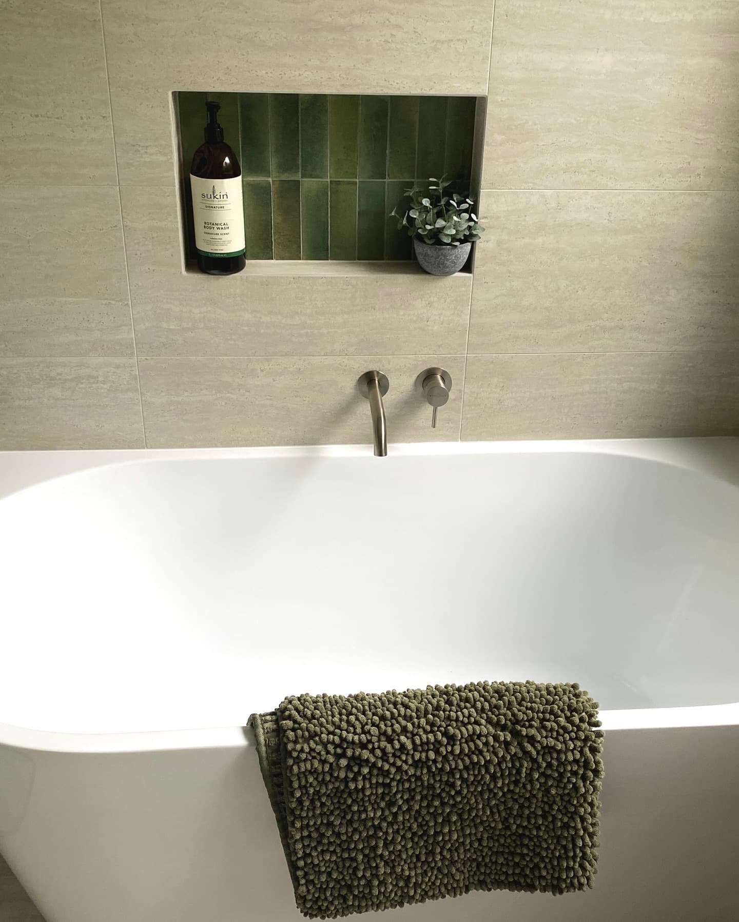 Bathroom detail — bath with green zellige tile niche