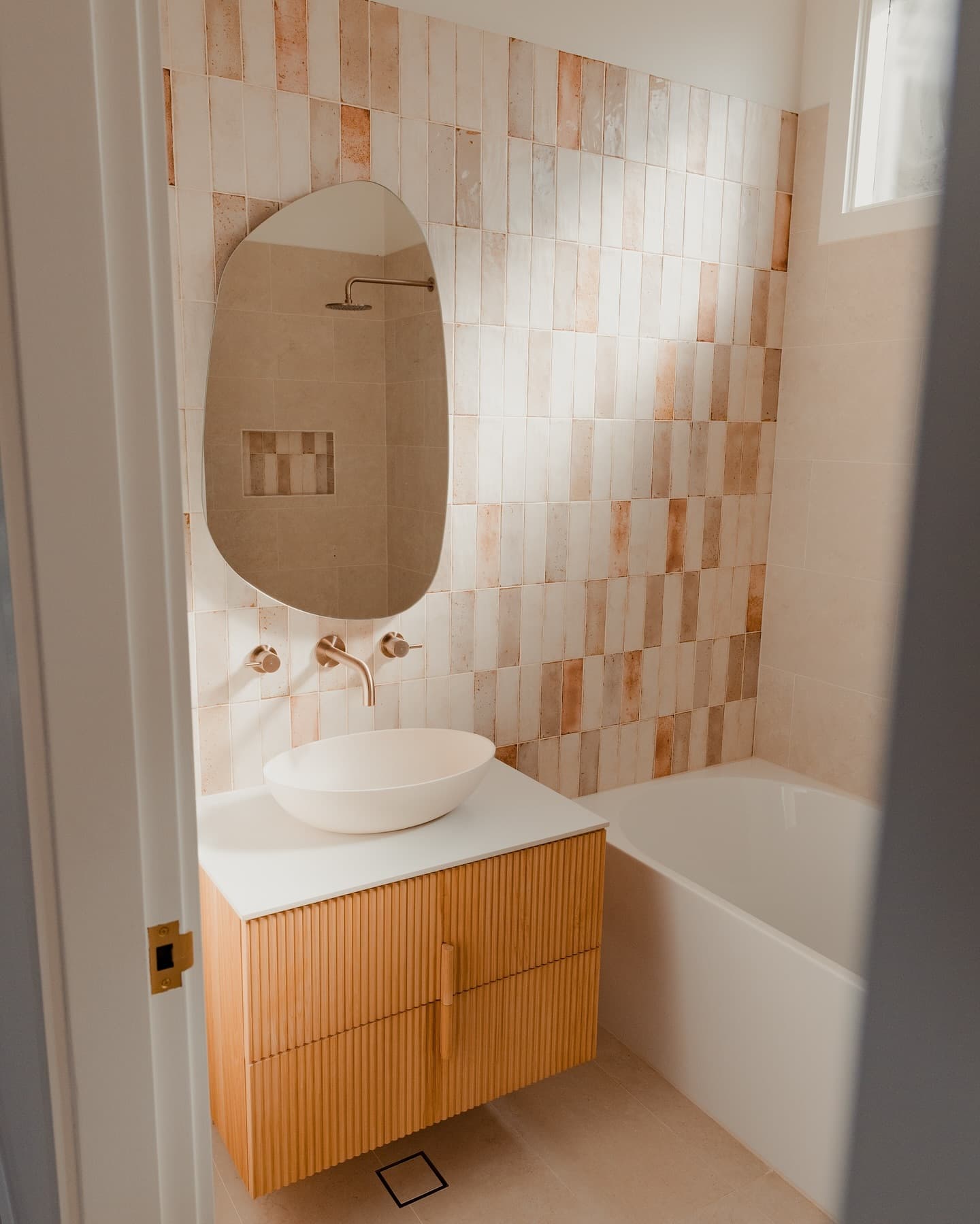 Bathroom renovation — terracotta tiles, oak vanity and brass fittings